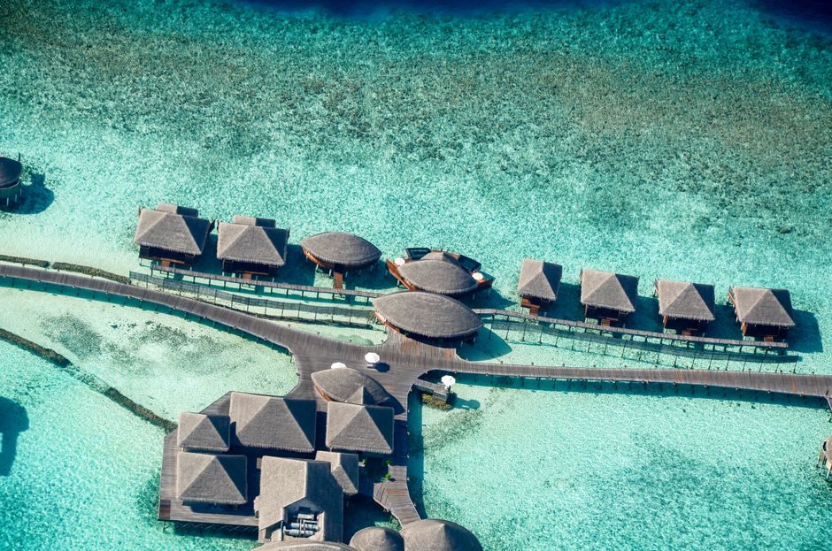 Overwater villas above a turquoise lagoon in the Maldives